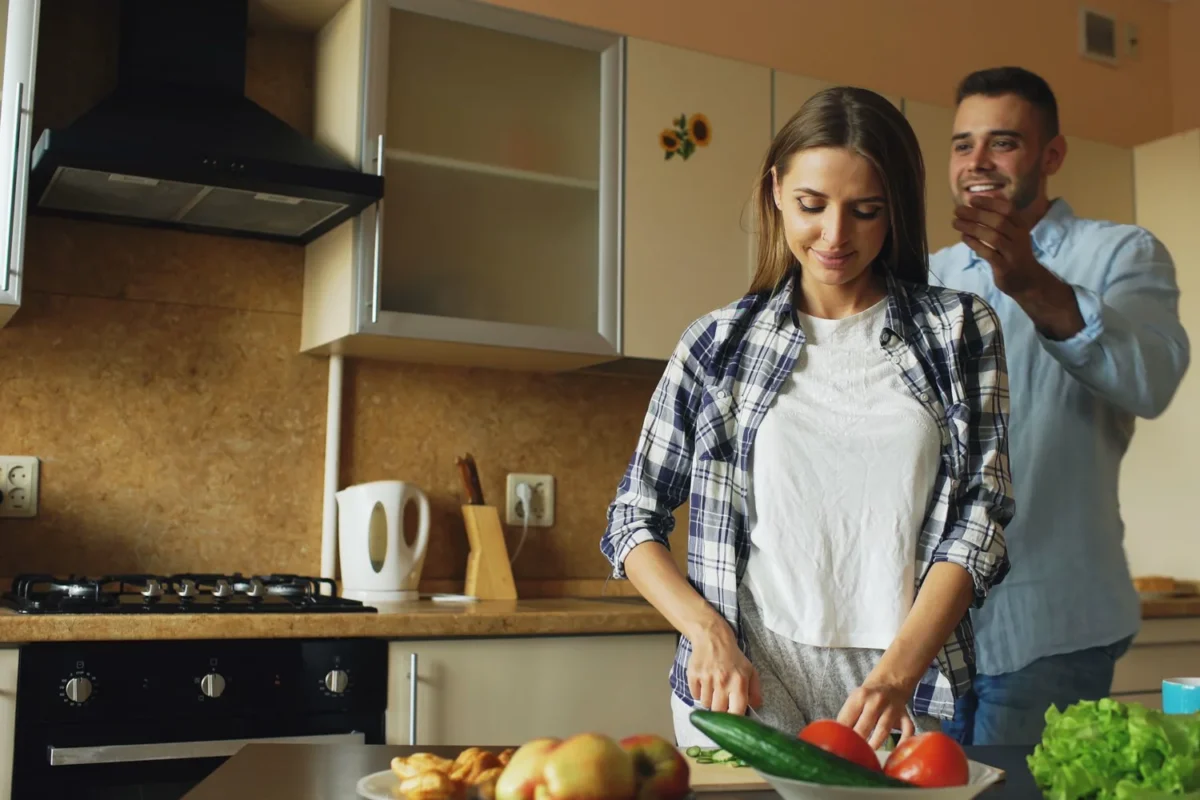 Couple preparing a healthy meal with fresh vegetables together in a modern home kitchen
