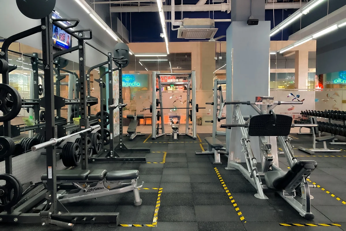 An empty gym with racks and weight training equipment