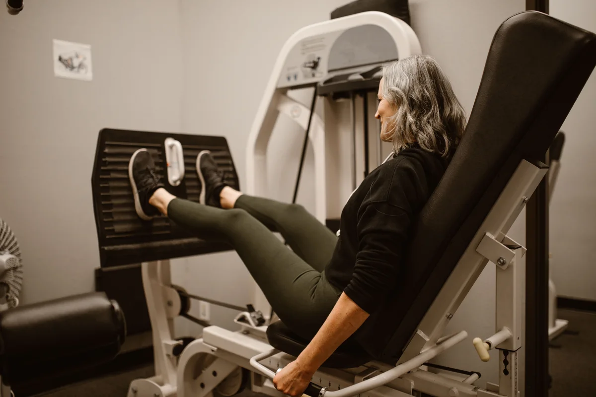 Woman using a leg press machine during a controlled gym workout